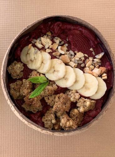 a bowl of food with bananas and nuts on top at Trianon Studios in Tsilivi