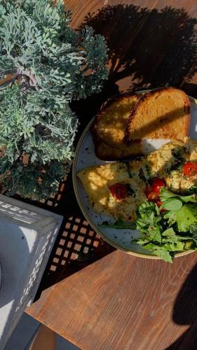 a plate of food with a sandwich and a salad at Trianon Studios in Tsilivi