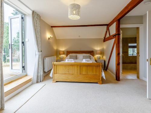 a bedroom with a bed and a large window at 3 Bed in Presteigne 78350 in Kinsham