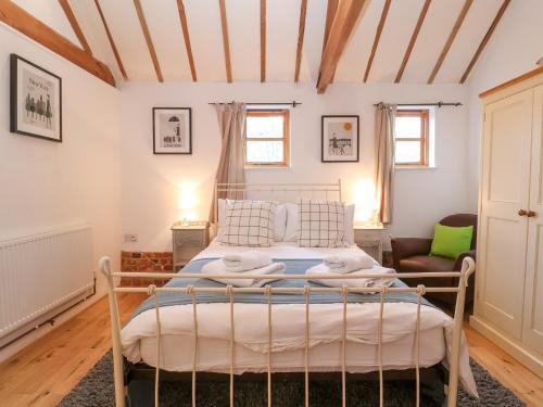 a bedroom with a bed in a room at Packway Barn in Halesworth