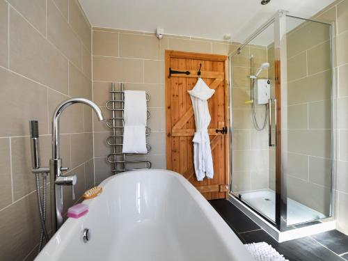 a bathroom with a bath tub and a shower at 2 bed in Conwy Valley SKN09 in Llanrwst