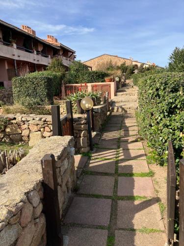 a stone path with a fence and a building at Casetta Spinnaker in Palau