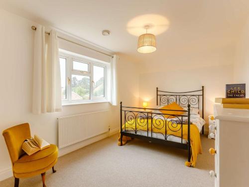 a bedroom with a bed and a chair and a window at 3 bed in Ross-on-Wye 89313 in Peterstow