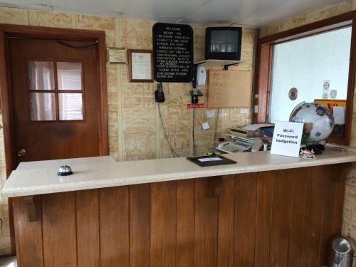 a kitchen with a counter with a counter top at Budget Inn - Scottsboro in Scottsboro