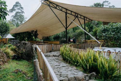a large tan tent over a wooden fence at Villa Situ Patenggang in Ciwidey