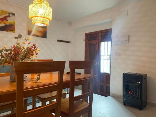 a dining room with a table and a fireplace at La casita de la fuente in Cazorla