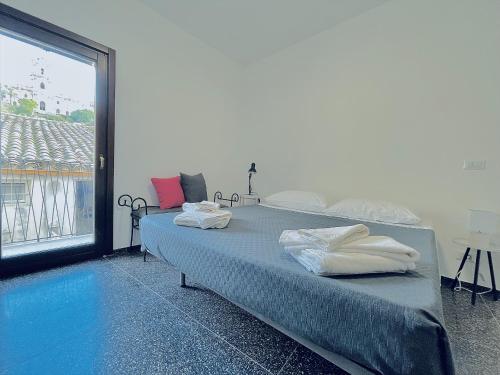 a bedroom with two beds and a large window at Casa Scribano in Modica