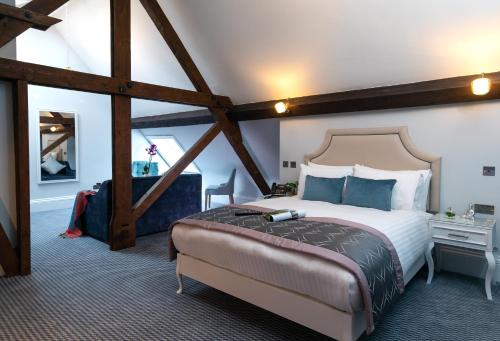 a bedroom with a large bed in a room at WA Hotel (Wroxall Abbey) in Wroxall