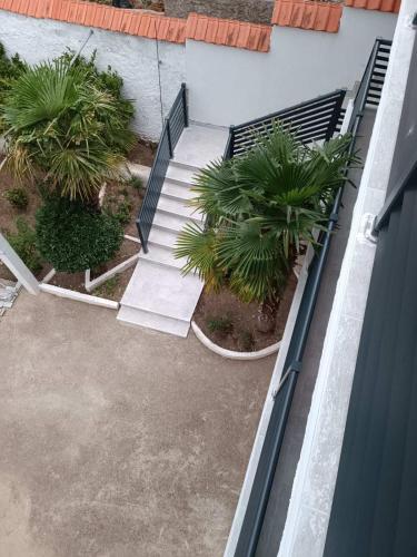 an overhead view of a stairway with palm trees at Apartments Daris in Mostar