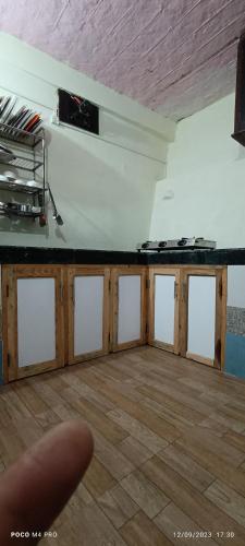 a room with a black counter and a wooden floor at The Moon Light Home stay in Bhīm Tāl