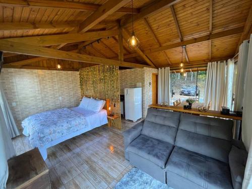a living room with a bed and a couch at Recanto Nascer do Sol in Aguas Mornas