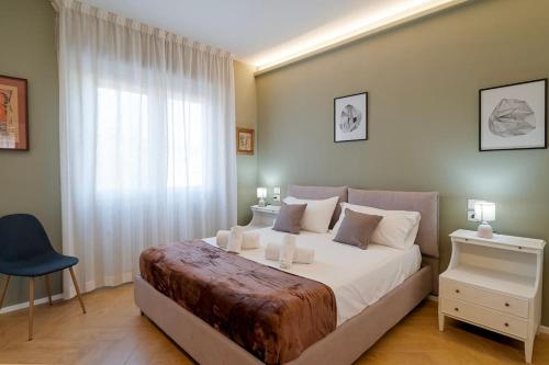 a bedroom with a large bed and a window at ARTpartment - 2 camere - WiFi - Garage in Vallecrosia