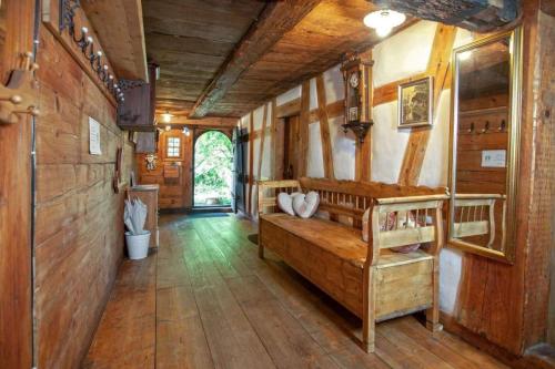 a bedroom with wooden walls and a wooden floor at Vogtshof Rottweil 