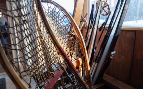 a bunch of skis are hanging on a wall at The Frenchman Suites in Silverton