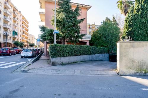 a street with cars parked on the side of a building at ARTpartment - 2 camere - WiFi - Garage in Vallecrosia