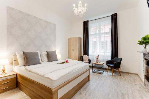 a bedroom with a large bed and a large window at Dream Apartments Prague in Prague
