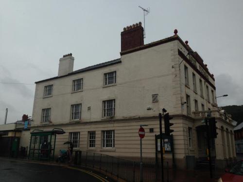 a white building on the corner of a street at Victoria hotel in Holywell