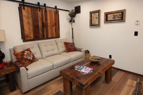 a living room with a couch and a table at The Frenchman Suites in Silverton
