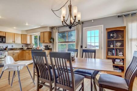 a kitchen with a dining room table and chairs at Whistler Hollow! Family Home, Bball Court, Firepit in Colorado Springs