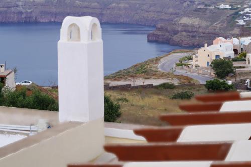 a view from the balcony of a church with a view of the water at Villa Galinia in Akrotiri