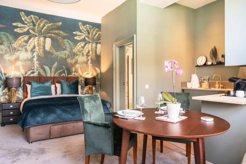 a bedroom with a bed and a wooden table and a dining room at Boutique Home Stay - Bliss Studio in Paisley