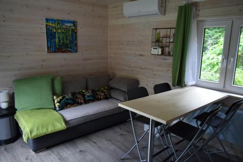 a living room with a couch and a table at Haus "Blücher" TinyHouse Mobilheim in Stuer