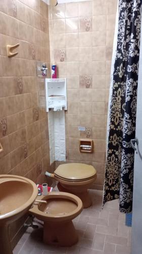 a bathroom with two toilets and a sink at Salta Paradise in San Bernardo
