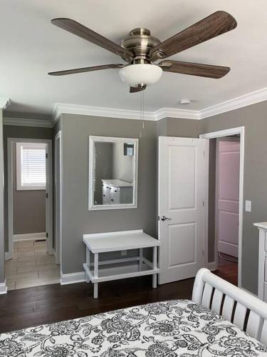 a bedroom with a bed and a ceiling fan at Huntersville House 3 bedrooms 2 Baths in Huntersville