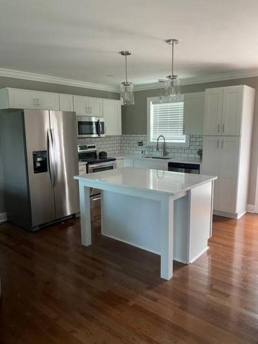 a kitchen with a white island in the middle at Huntersville House 3 bedrooms 2 Baths in Huntersville