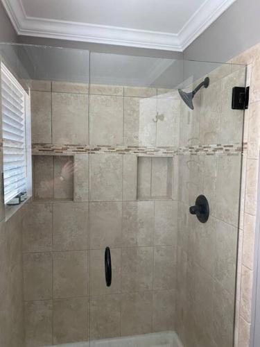 a shower with a glass door in a bathroom at Huntersville House 3 bedrooms 2 Baths in Huntersville