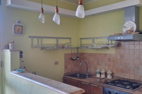 a kitchen with a sink and a counter top at 4US: A cosy glamour stay on the sea 4YOU! in Vibo Valentia Marina