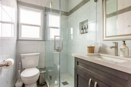 a bathroom with a toilet and a shower and a sink at AMAZING OCEAN VIEW - LUXURY Manhattan Beach 1 Bedroom - Parking in Manhattan Beach