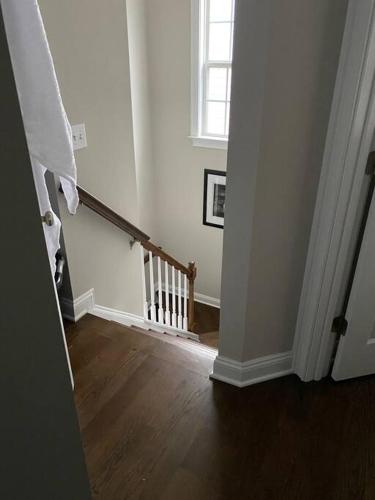 a hallway with a stairway with a window and a stair case at Davidson House - 3 beds 2.5 baths in Davidson