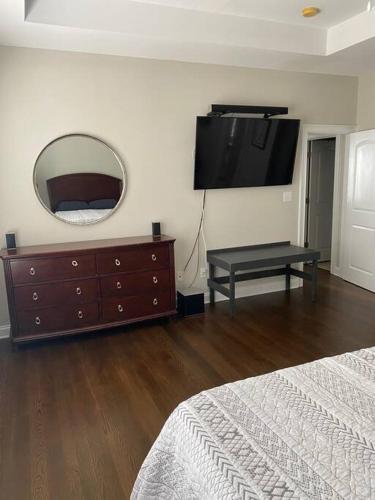 a bedroom with a dresser and a mirror and a bed at Davidson House - 3 beds 2.5 baths in Davidson