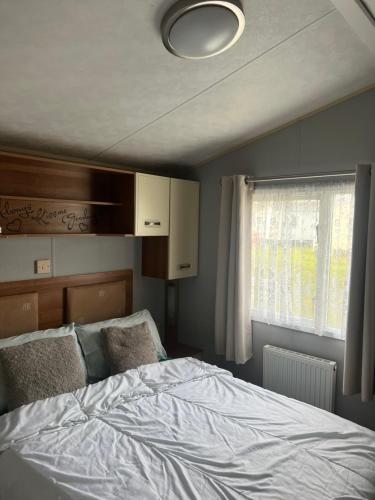 a bedroom with a bed and a window at Tattershall lakes in Tattershall