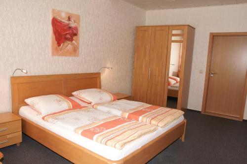 a bedroom with a bed with two pillows on it at Alte Winzerschenke in Bruttig-Fankel