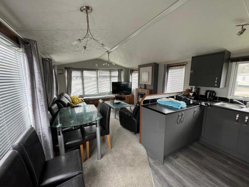 a kitchen and a living room with a table at Tattershall lakes in Tattershall