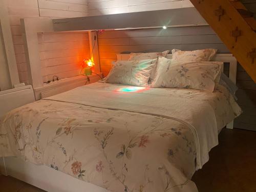 ラ・プティット・ピエールにあるLa Dependance de la Villa des Oiseaux - La Petite Pierreの白いベッド1台(木製ヘッドボード付)が備わるベッドルーム1室が備わります。