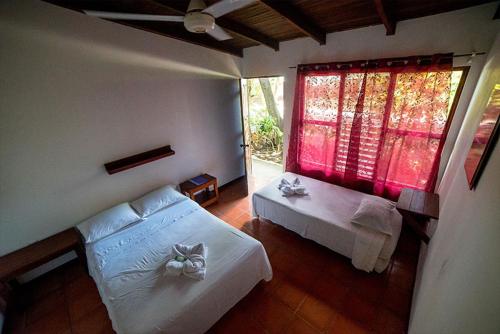 Postel nebo postele na pokoji v ubytování Hotel Hibiscus Cabina 4