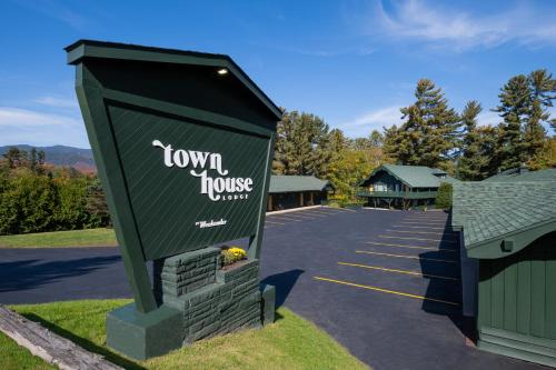 a sign for a town house in a parking lot at Town House Lodge in Lake Placid