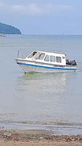 a small boat in the water near a beach at Edificio Agustin in Bahía Solano