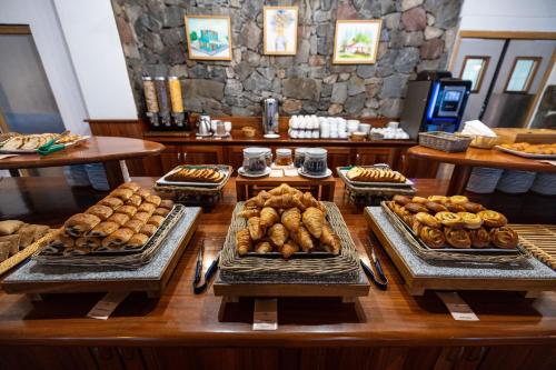 a table with different types of pastries on it at Le Vieux Cep in Cilaos