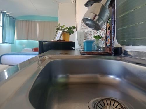 a kitchen counter with a sink in a kitchen at The Dreamcatcher Bus in Sarchí