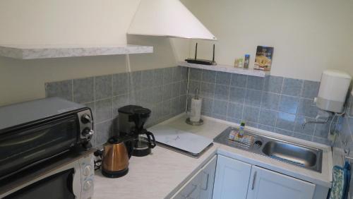 a kitchen with a sink and a counter top at Fewo 91 WHG A 14 in Burhave in Burhave