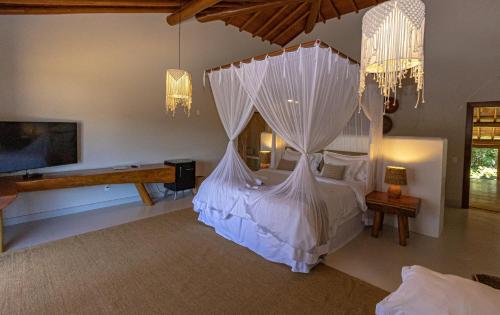 A bed or beds in a room at Aysú Trancoso Hotel