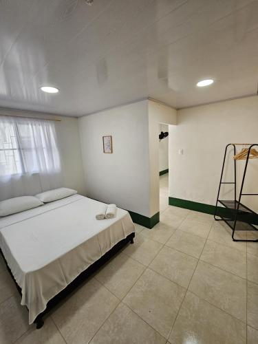 a bedroom with a bed and a ladder in it at Celestino - Casa de Huespedes in Guaduas