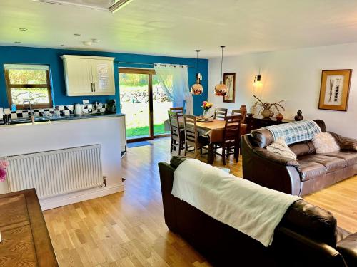a living room with a couch and a table at Yr Encil in Gaerwen