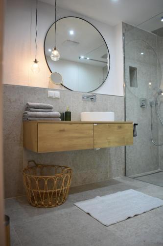 a bathroom with a sink and a mirror at FEWO Studio7 in Vorderelsenwang