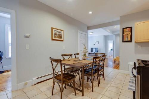 a kitchen and dining room with a table and chairs at NEW! Boston Condo Near MBTA, 3Mi to Fenway! (U1) in Boston
