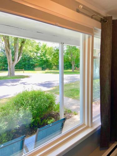 a window with a view of a park at Elk Rapids Lakeshore Inn in Elk Rapids